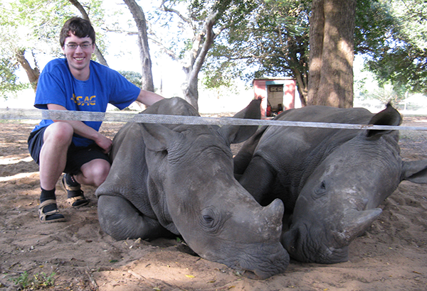 Alexander Burrows with rhinos in South Africa